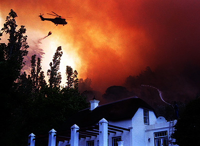 Helicopters over a cape forest fire